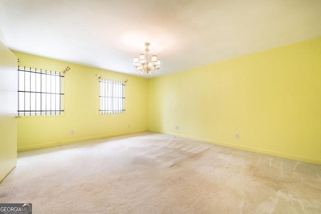 6909 Forsyth Rd, Macon, GA 31210 - spare room featuring a chandelier and light carpet