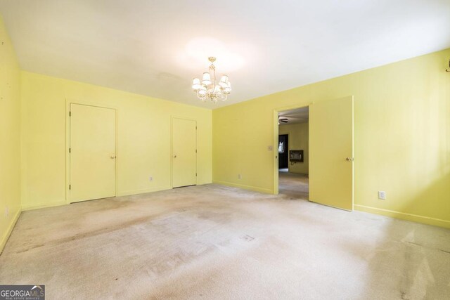 6909 Forsyth Rd, Macon, GA 31210 - spare room with a chandelier and light carpet