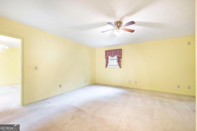 spare room featuring ceiling fan and light carpet