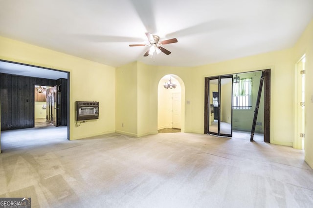 6909 Forsyth Rd, Macon, GA 31210 - spare room with heating unit, light colored carpet, ceiling fan, and arched walkways