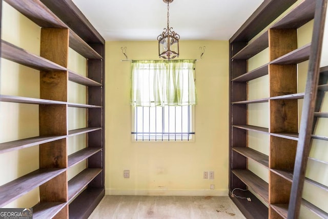 walk in closet featuring light colored carpet