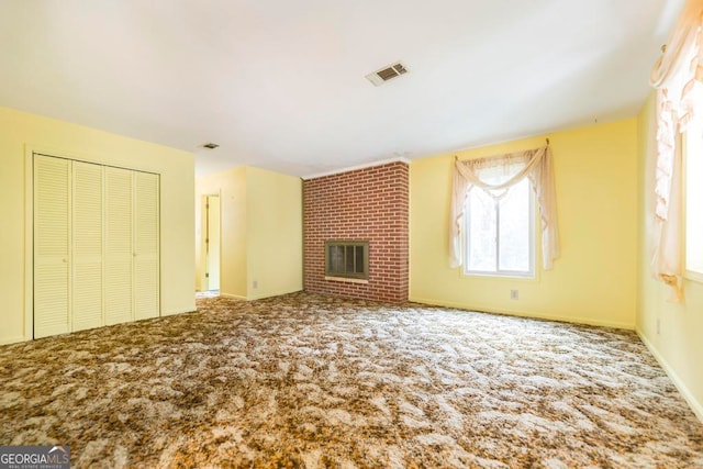 unfurnished living room with a fireplace and carpet