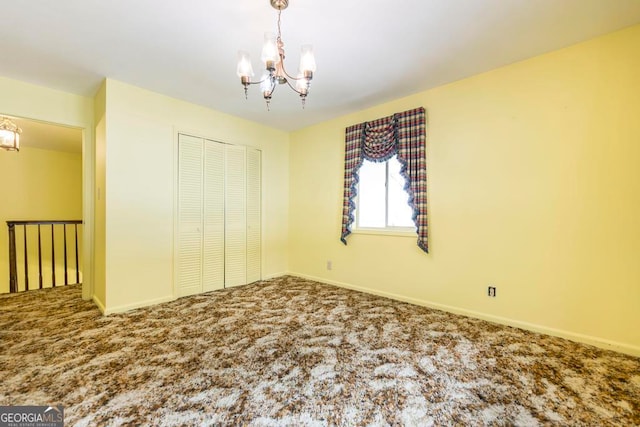 unfurnished bedroom featuring a chandelier, carpet floors, and a closet