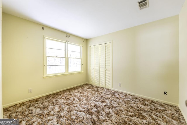 6909 Forsyth Rd, Macon, GA 31210 - unfurnished bedroom featuring carpet and a closet