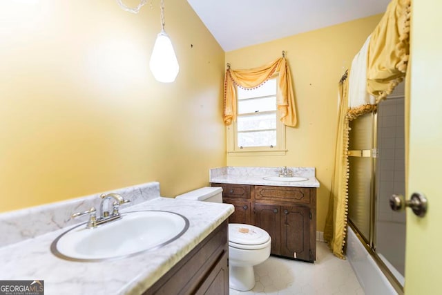 full bathroom featuring vanity, toilet, lofted ceiling, and bath / shower combo with glass door