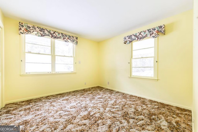 carpeted empty room with a wealth of natural light