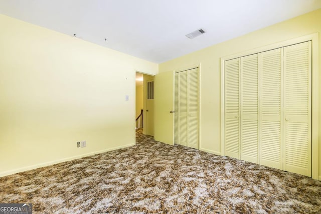 6909 Forsyth Rd, Macon, GA 31210 - unfurnished bedroom featuring two closets and carpet floors