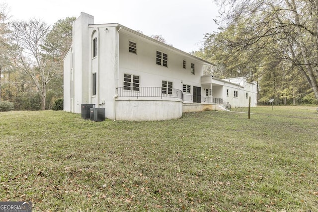 6909 Forsyth Rd, Macon, GA 31210 - back of property featuring a chimney, a yard, and stucco siding