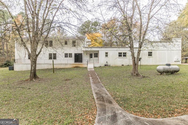 view of front of house featuring french doors and a front lawn