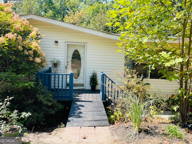 entrance to property with a wooden deck