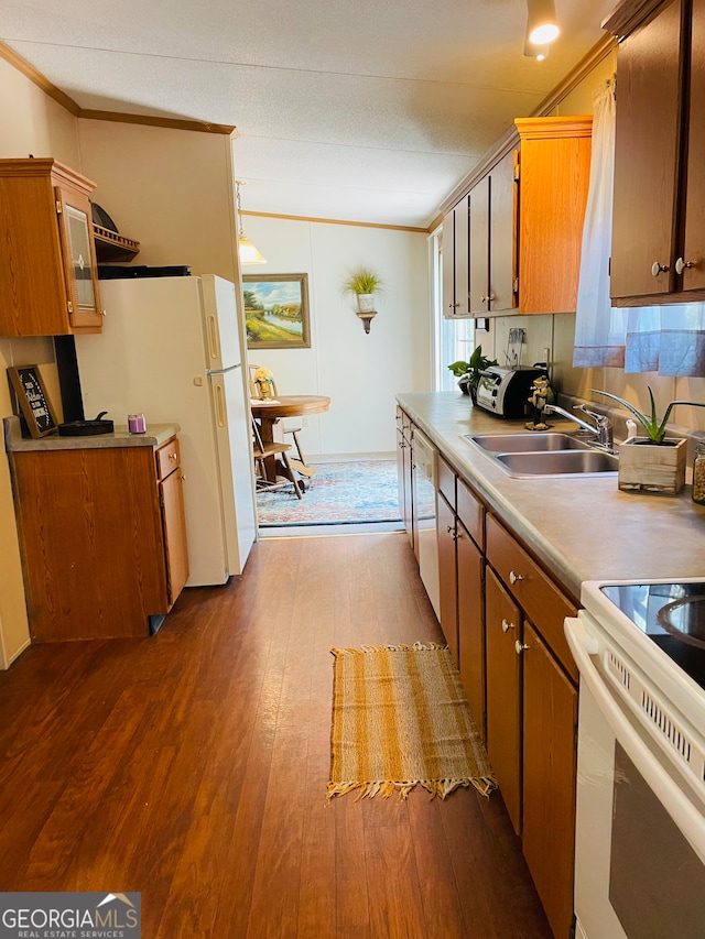 kitchen with hardwood / wood-style floors, white appliances, sink, and ornamental molding