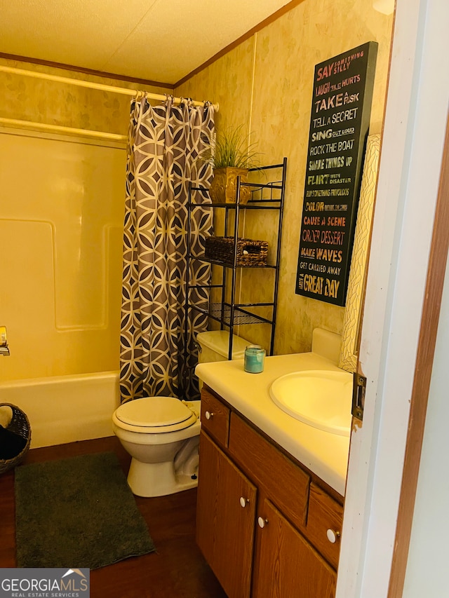 full bathroom featuring shower / tub combo, ornamental molding, vanity, wood-type flooring, and toilet