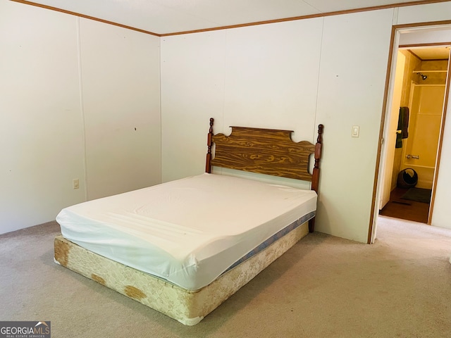 carpeted bedroom featuring ensuite bath