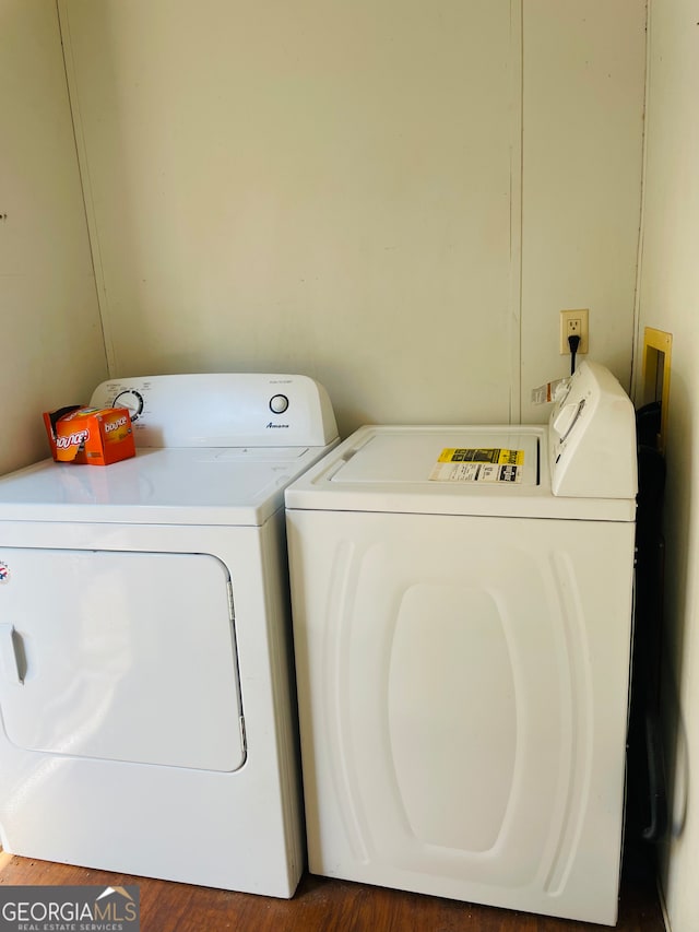 laundry room with separate washer and dryer and dark wood-type flooring