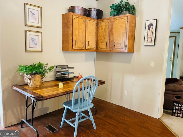 home office with dark hardwood / wood-style floors