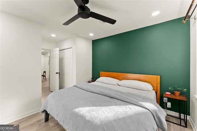 bedroom with light hardwood / wood-style flooring and ceiling fan