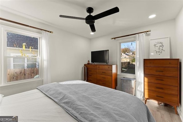 bedroom with ceiling fan and light hardwood / wood-style floors