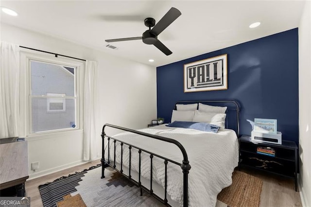 bedroom featuring hardwood / wood-style flooring and ceiling fan