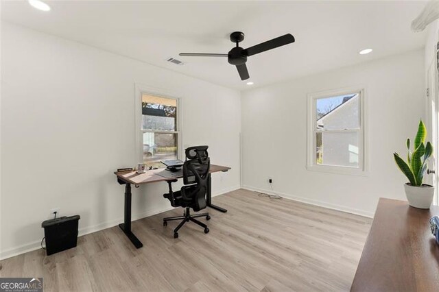 home office featuring ceiling fan, a healthy amount of sunlight, and light wood-type flooring