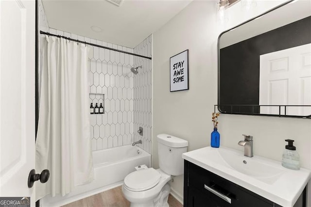 full bathroom with hardwood / wood-style floors, vanity, toilet, and shower / bath combination with curtain