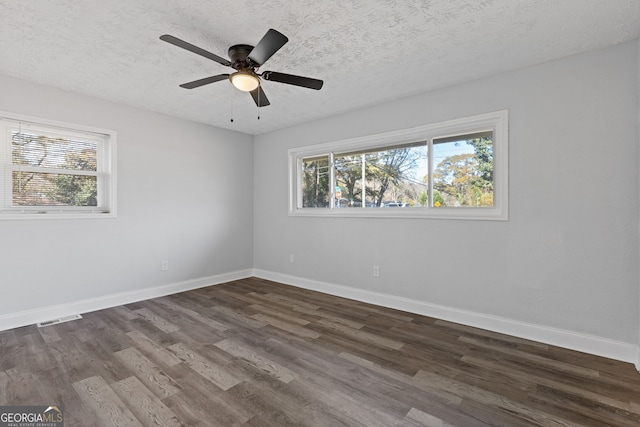 unfurnished room featuring a textured ceiling, dark hardwood / wood-style flooring, and ceiling fan