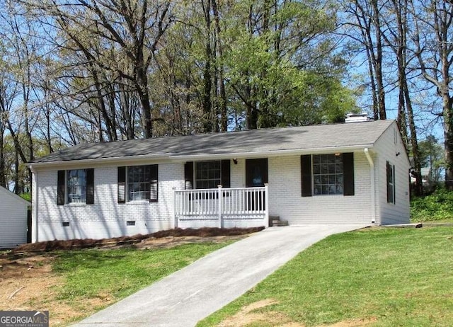 ranch-style home with covered porch and a front yard