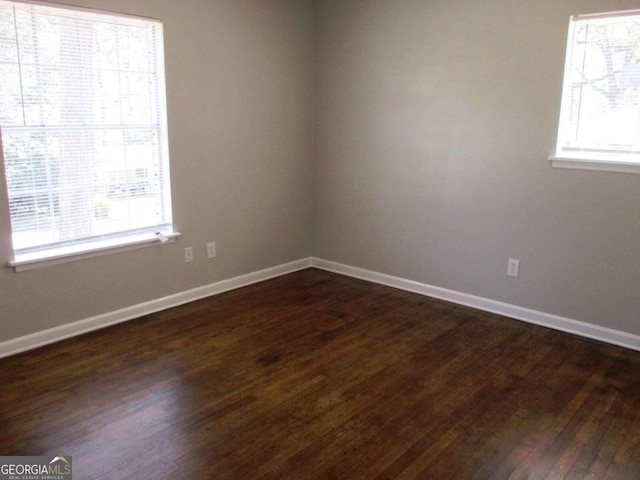 spare room featuring dark hardwood / wood-style flooring