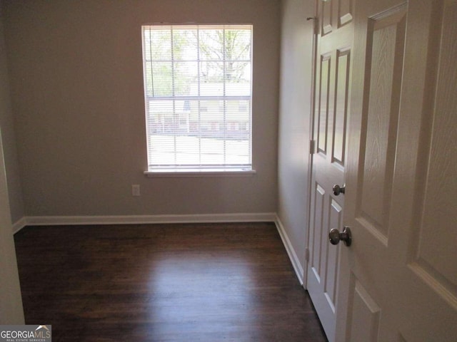 spare room with dark hardwood / wood-style flooring