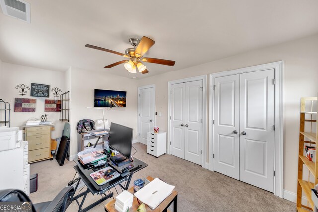 carpeted home office featuring ceiling fan and a healthy amount of sunlight