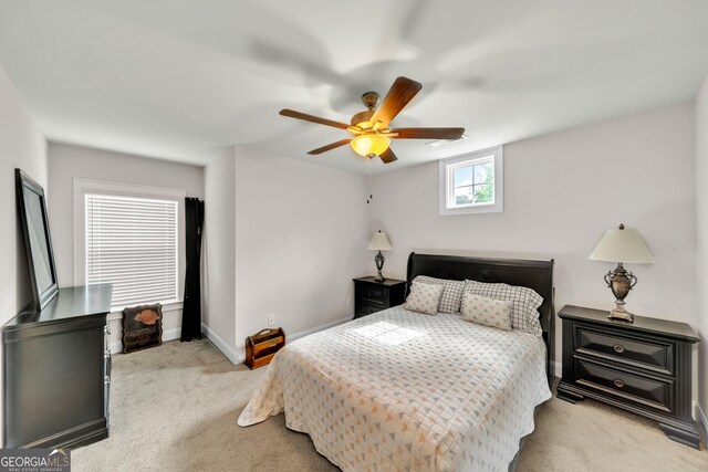 carpeted office space featuring ceiling fan