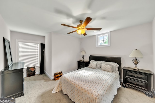 bedroom with light colored carpet and ceiling fan