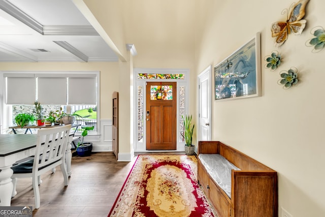 entryway with beamed ceiling, dark wood-type flooring, coffered ceiling, and ornamental molding