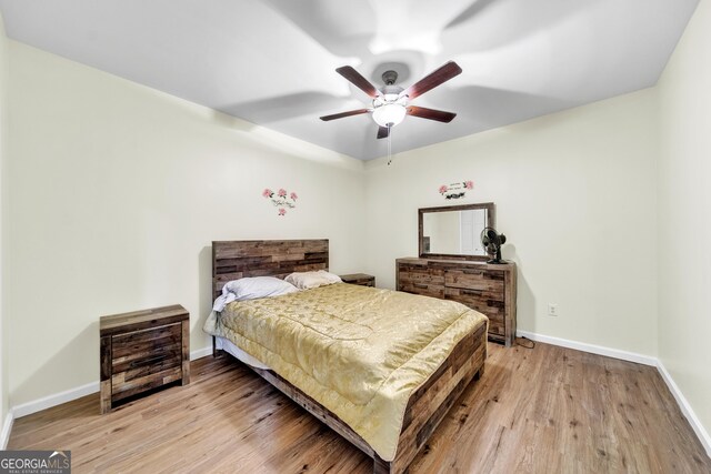 home office featuring light hardwood / wood-style floors and ceiling fan