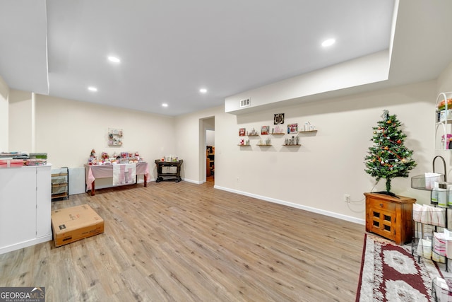 recreation room featuring light wood-type flooring