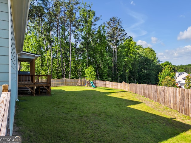 view of yard featuring a playground and a wooden deck