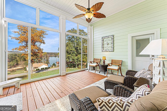 sunroom / solarium featuring ceiling fan, a healthy amount of sunlight, and a water view