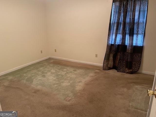 spare room featuring carpet floors