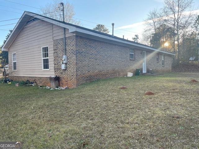 view of home's exterior featuring a yard