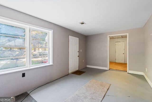 foyer entrance featuring concrete flooring