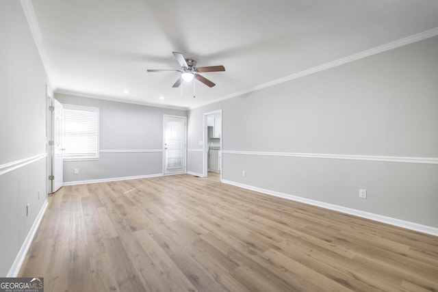 empty room featuring ceiling fan, light hardwood / wood-style floors, and ornamental molding