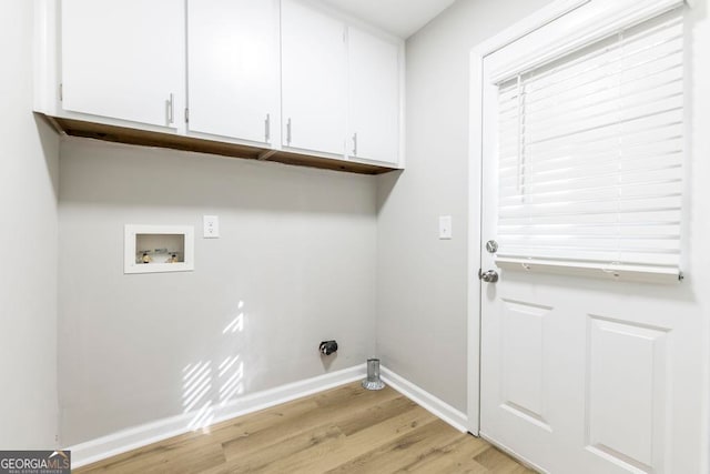 laundry room with cabinets, hookup for a washing machine, and light hardwood / wood-style flooring