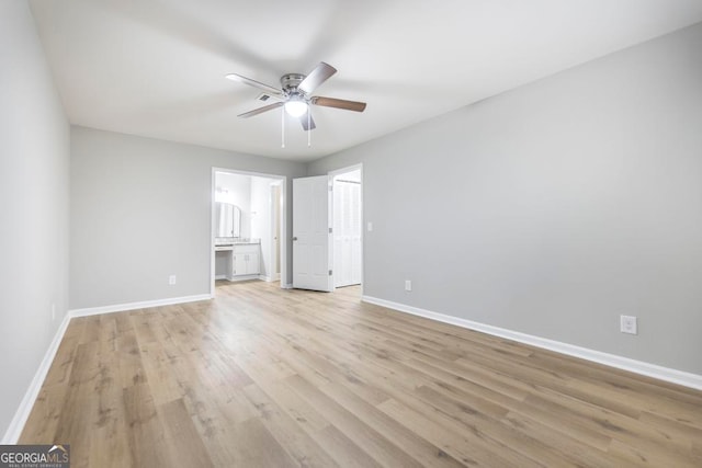 unfurnished bedroom with connected bathroom, light hardwood / wood-style floors, and ceiling fan