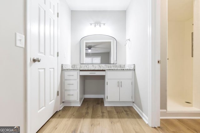 bathroom featuring a shower, ceiling fan, hardwood / wood-style floors, and vanity