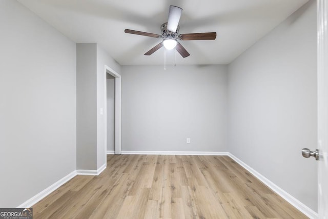 unfurnished room with light wood-type flooring and ceiling fan