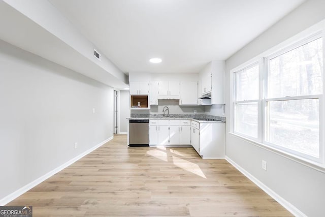 kitchen with dishwasher, white cabinetry, sink, and light hardwood / wood-style flooring