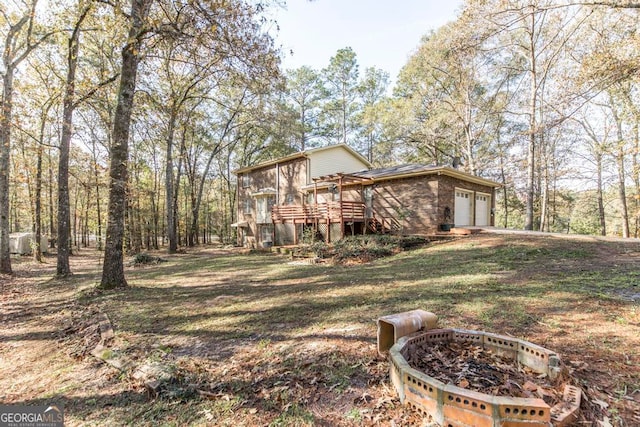 exterior space featuring a wooden deck and a garage