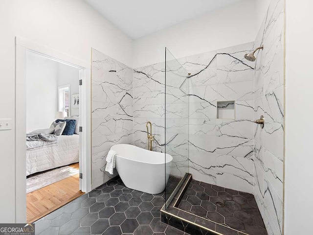 bathroom with hardwood / wood-style floors and independent shower and bath