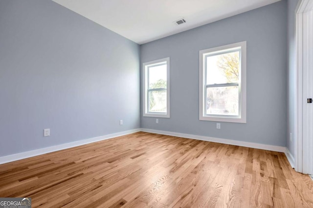 spare room featuring light wood-type flooring