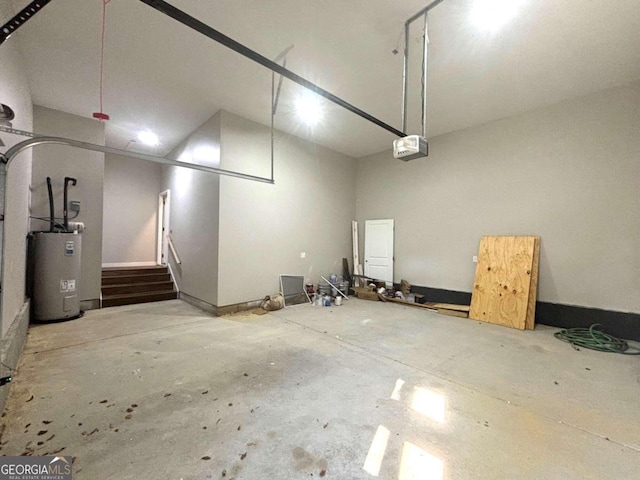 garage with electric water heater and a garage door opener