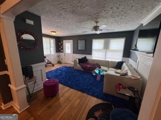 living room featuring hardwood / wood-style flooring, a healthy amount of sunlight, and a textured ceiling